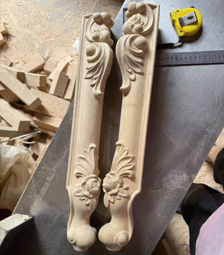 Carved wooden furniture legs with floral details
