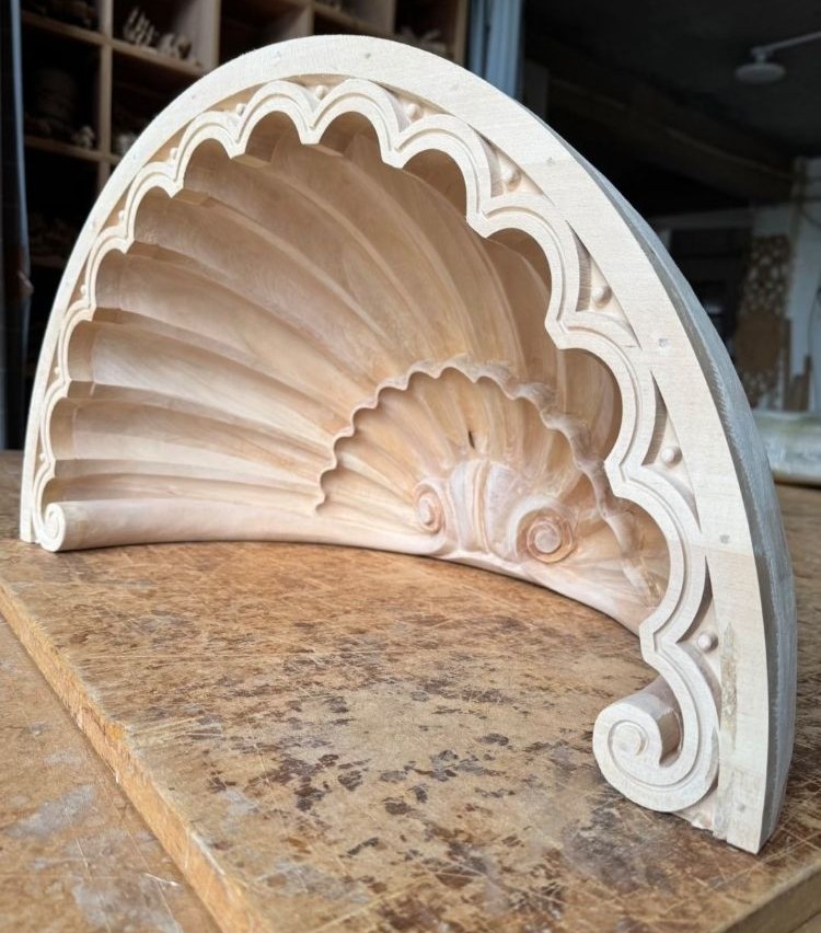 Custom curved carved wood component with shell design